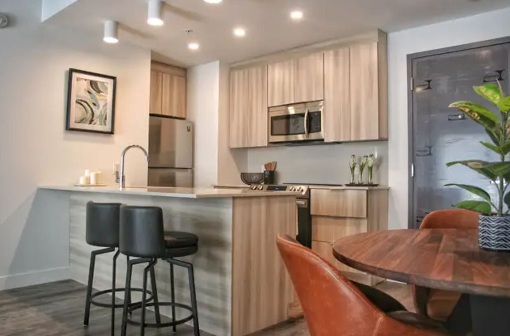 a kitchen with a bar and a dining table