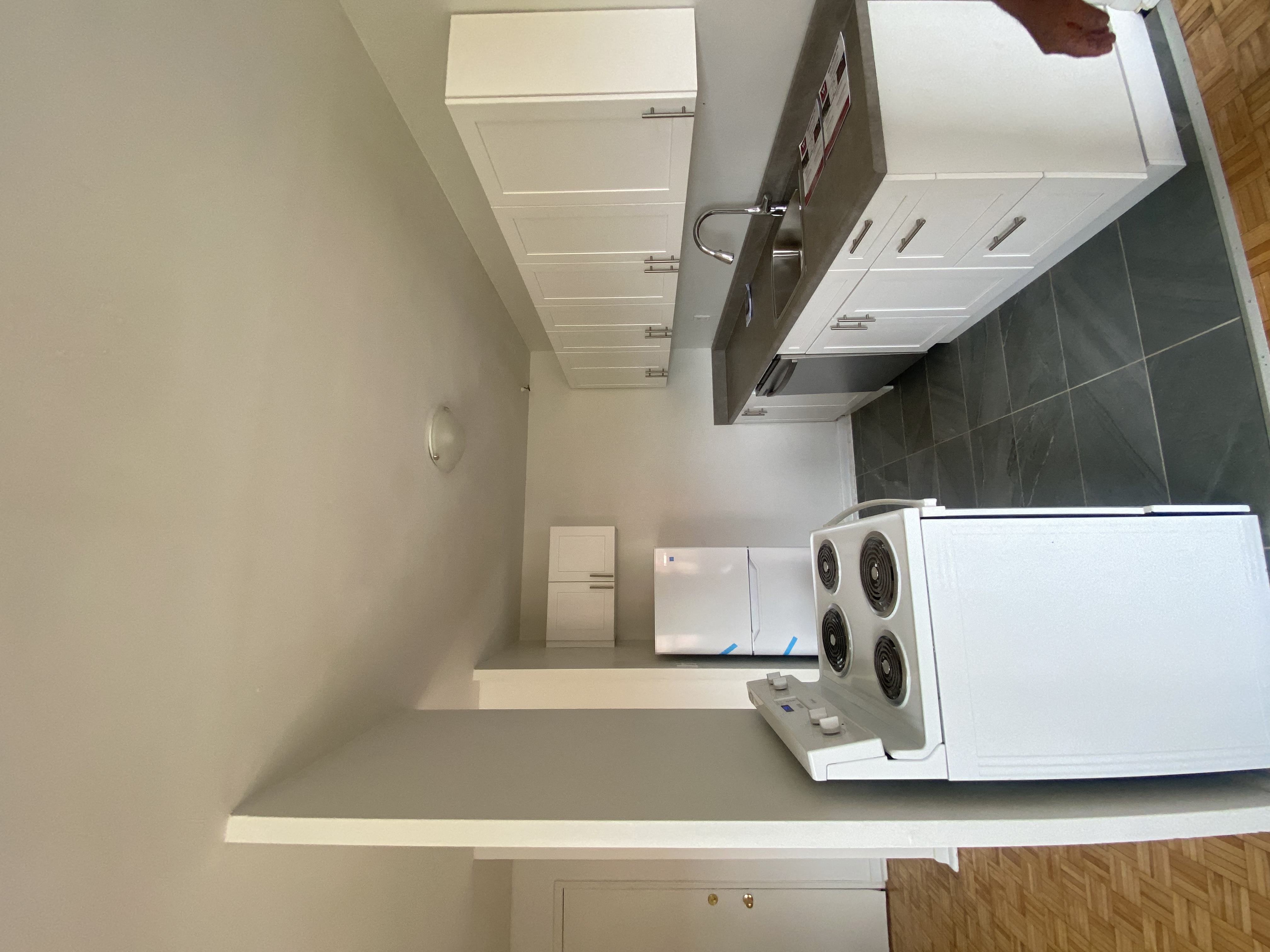 a kitchen with a microwave and a refrigerator on a counter