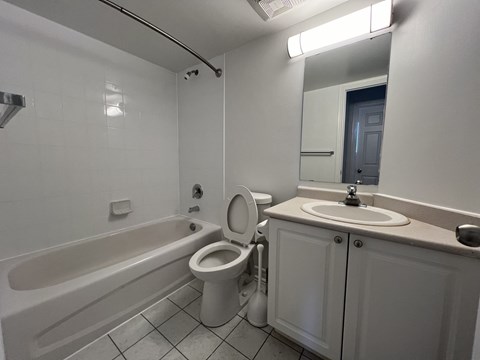 an empty bathroom with a sink toilet and bath tub