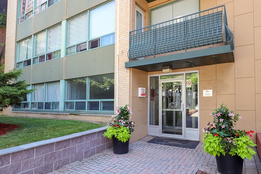 the entrance to a building with flowers in front of it