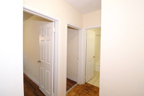 a bedroom with two closets and a door to a bathroom