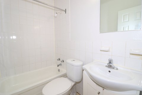 a white bathroom with a sink toilet and bath tub