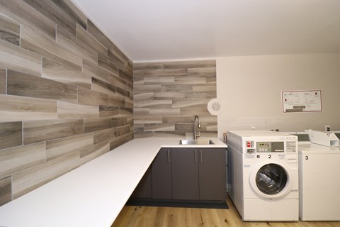 a kitchen with a washing machine and a washer and dryer in it