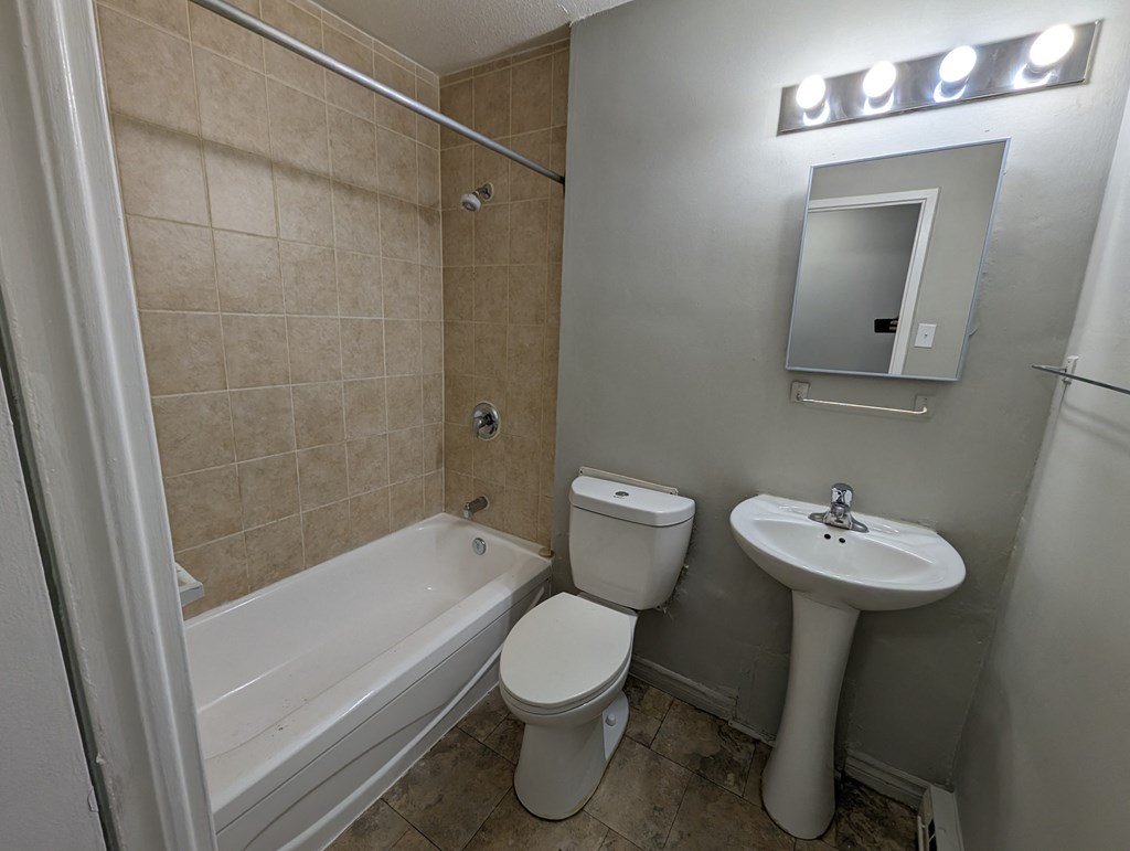 a bathroom with a sink toilet and a tub