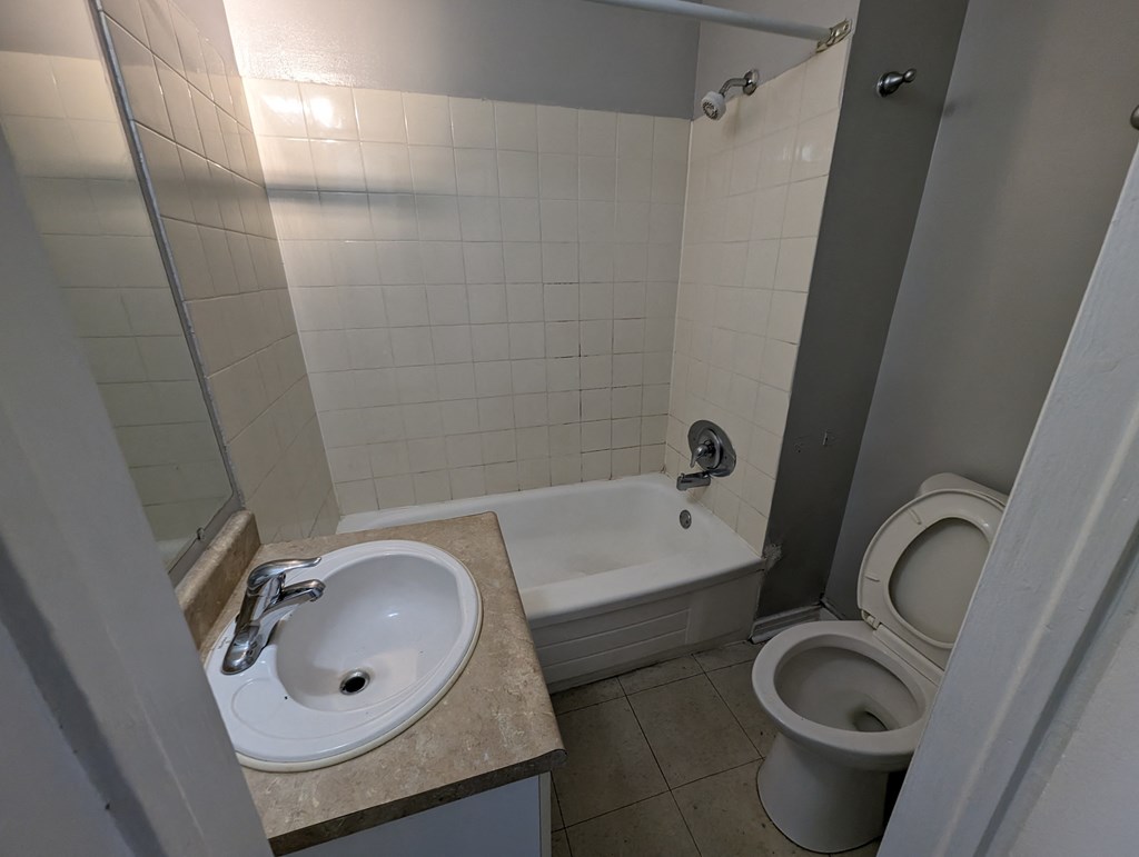an empty bathroom with a sink toilet and tub