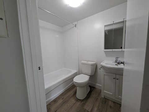an empty bathroom with a toilet sink and tub