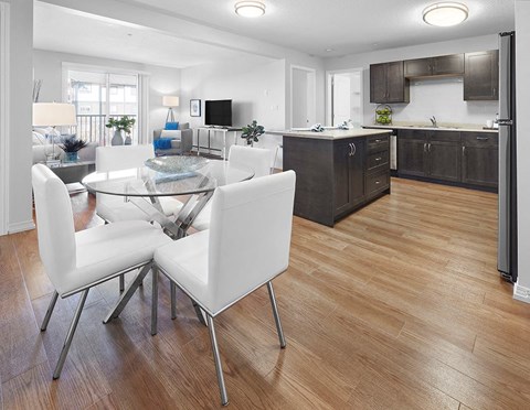 a kitchen and dining room with a table and chairs