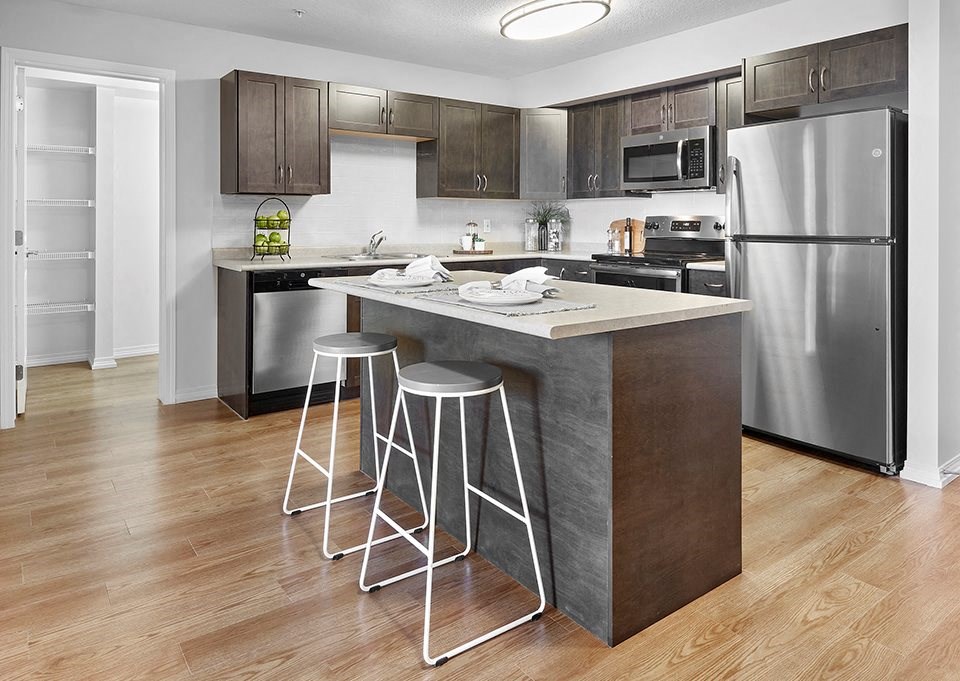 a kitchen with a center island and three bar stools