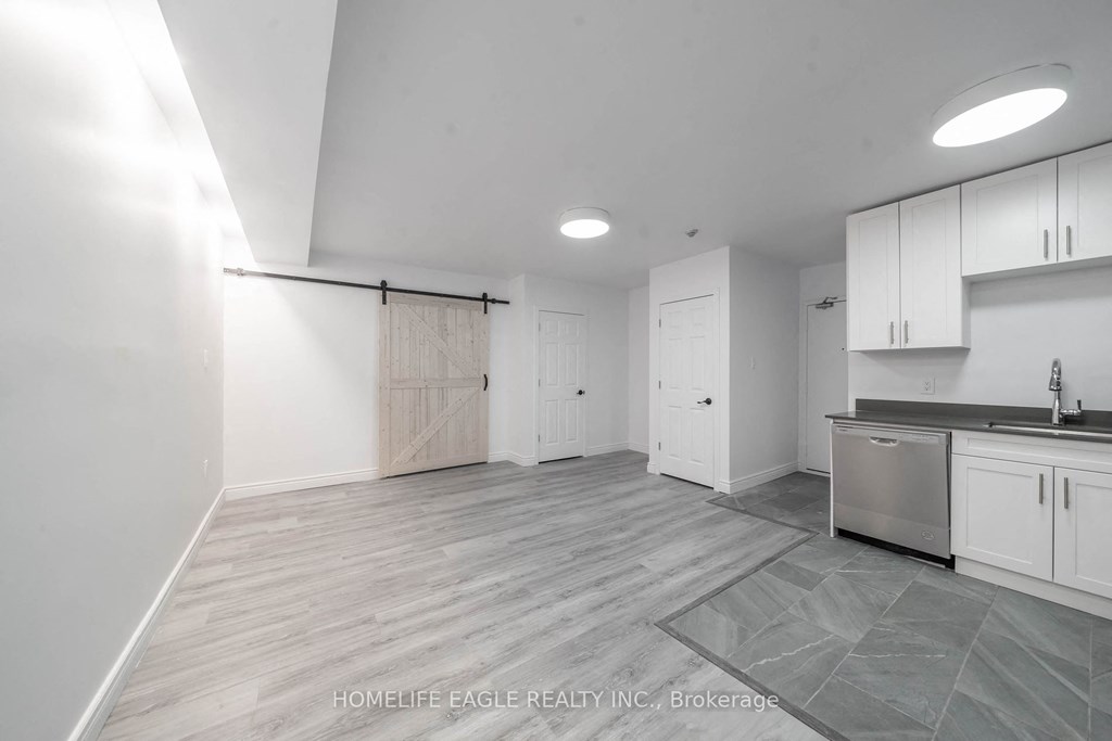 a renovated kitchen with white cabinets and stainless steel appliances
