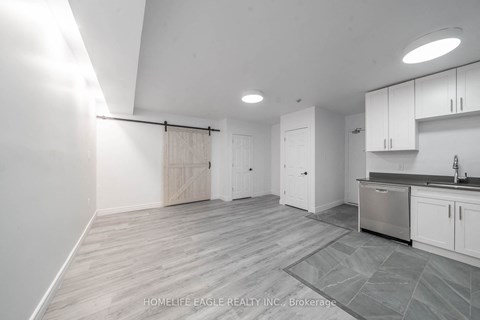a renovated kitchen with white cabinets and stainless steel appliances