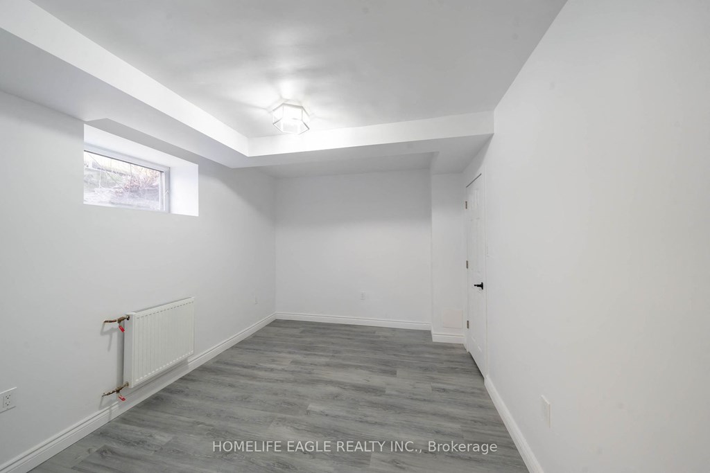 a bedroom with white walls and a white door and a window