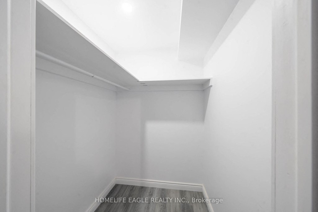 a small room with white walls and a window