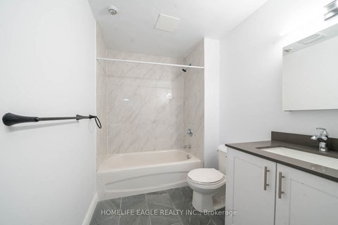 a white bathroom with a toilet sink and tub and a shower