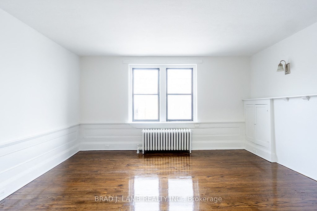 an empty room with a radiator and a window