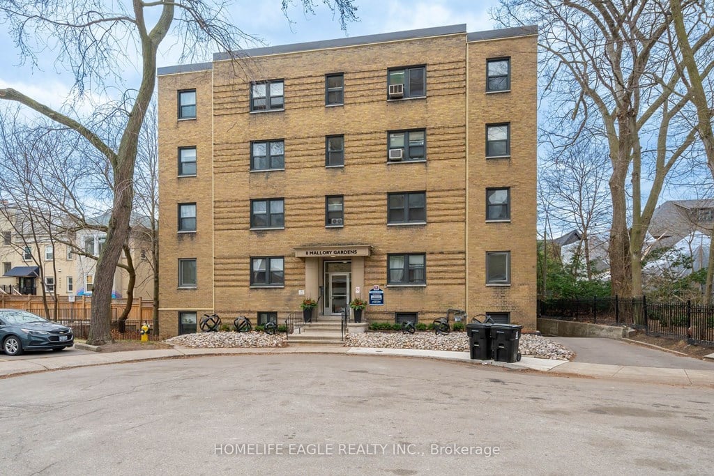 a large brick apartment building with a parking lot