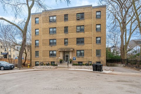 a large brick apartment building with a parking lot
