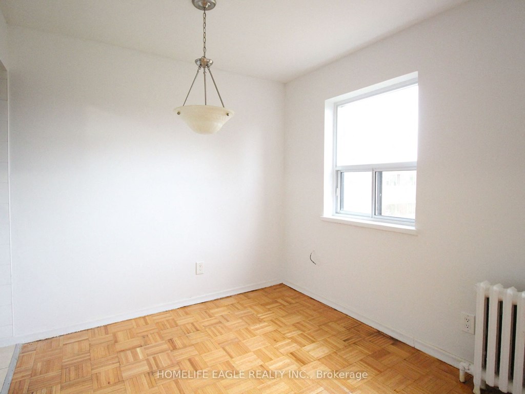 an empty room with a window and a lamp