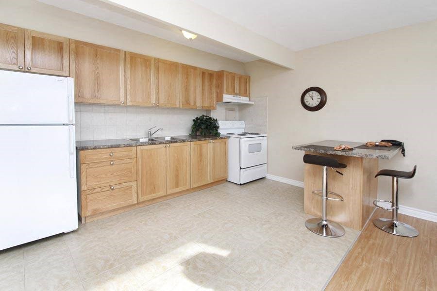 a kitchen with wooden cabinets and a white refrigerator