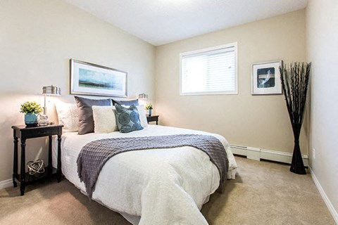 a bedroom with a bed and a window