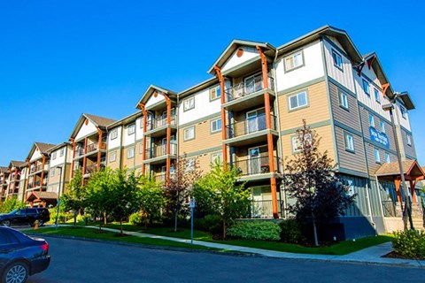 a row of apartment buildings on the side of a street