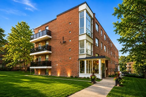 A red brick building with a balcony on the second floor.