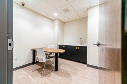 a dining area with a table and chairs in a room with a kitchen