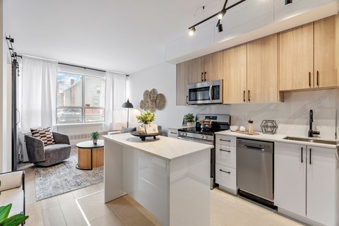 A modern kitchen with white cabinets and a large island.