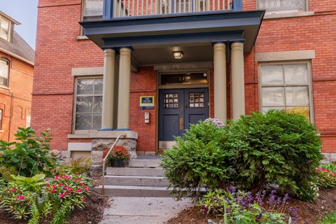 A red brick building with a black door and windows.