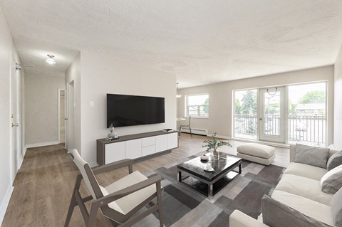 A modern living room with a flat screen TV mounted on the wall.