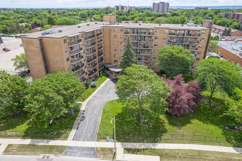 A large apartment complex with a green lawn in front.