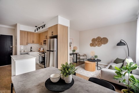 A modern kitchen with a dining table and chairs.