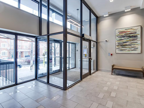 A hallway with a bench and a painting on the wall.
