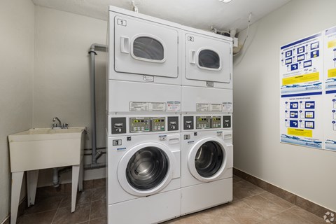 A wall of washing machines in a laundromat.