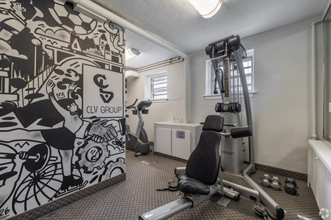 A gym room with a CIVILIAN GROUP wallpaper.