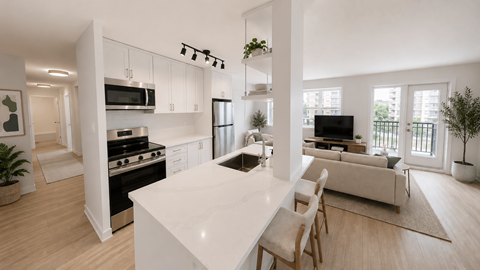 A modern kitchen with a white countertop and wooden flooring.
