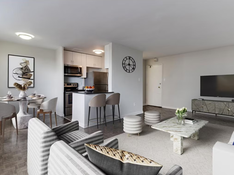 A living room with a grey couch and a white coffee table.