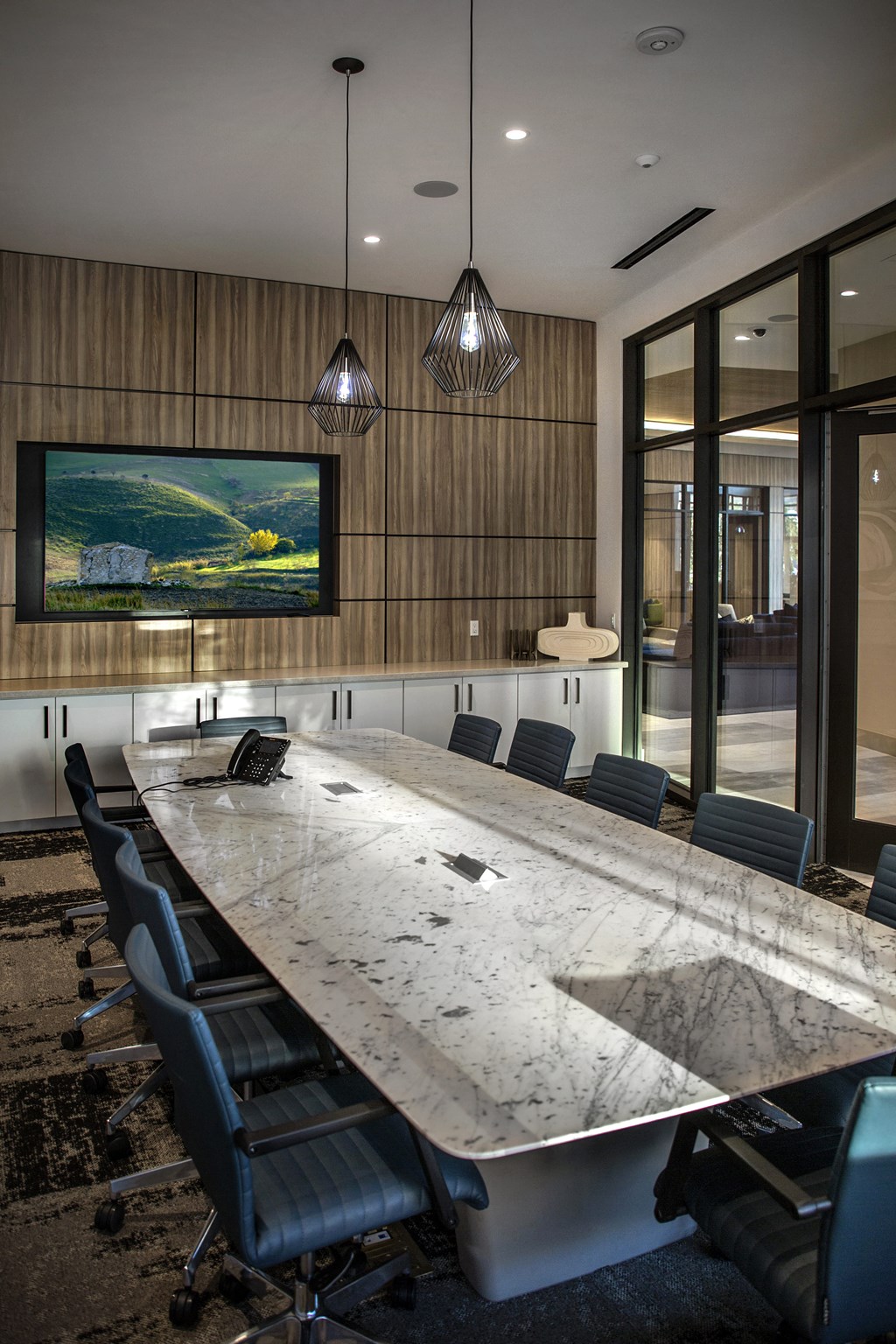 A conference room with a long table and chairs A conference room with a long table and chairs at Purl Apartments, San Diego, California