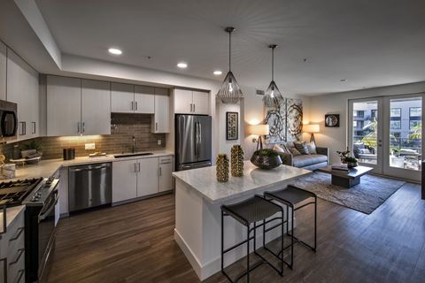 a kitchen and living room in an open floor plan with a large center island