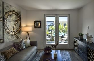 a living room with a couch and a door to a patio