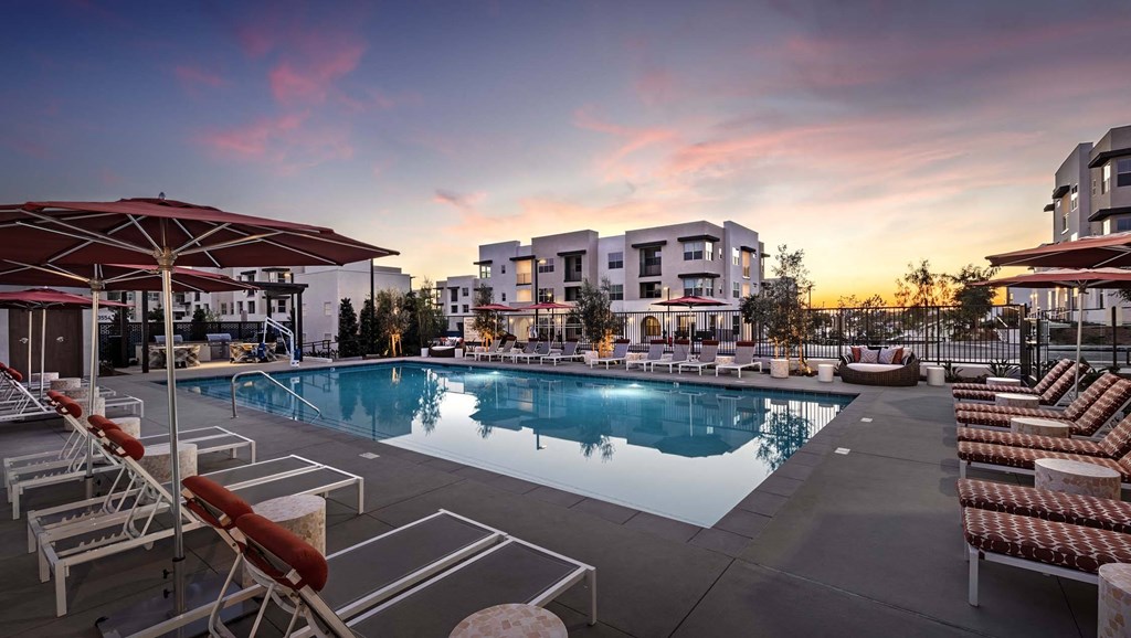 a swimming pool at dusk at Luma at El Corazon Apartments, Oceanside, California