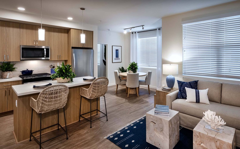 a living room and kitchen with a couch and a table at Luma at El Corazon Apartments, Oceanside