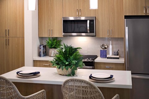 a kitchen with a counter and a table with chairs