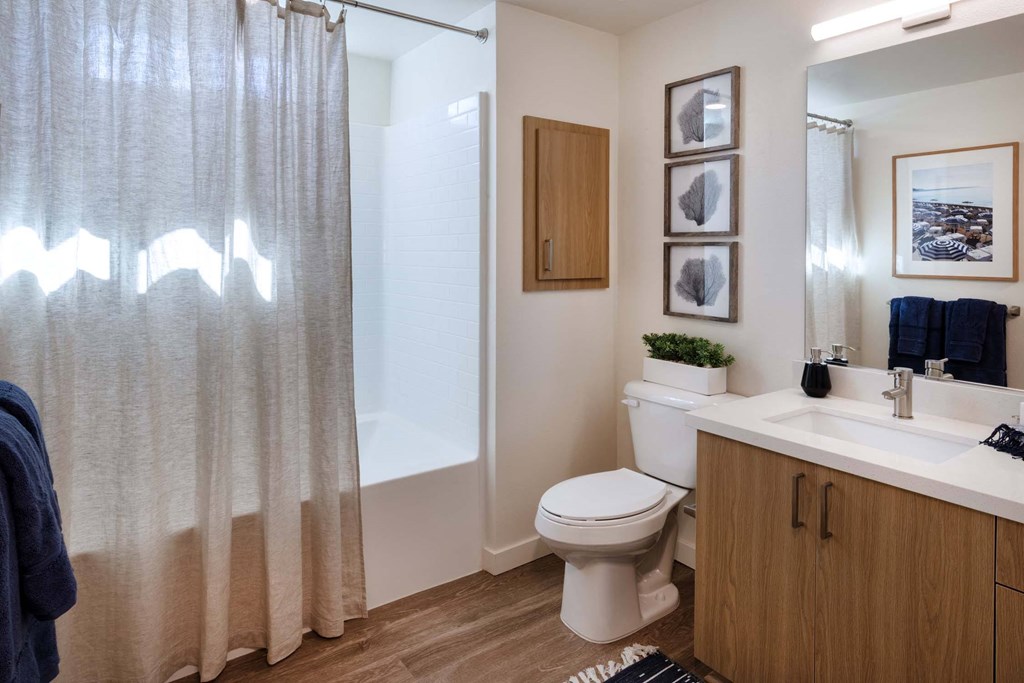 a bathroom with a shower and a toilet and a sink at Luma at El Corazon Apartments, Oceanside