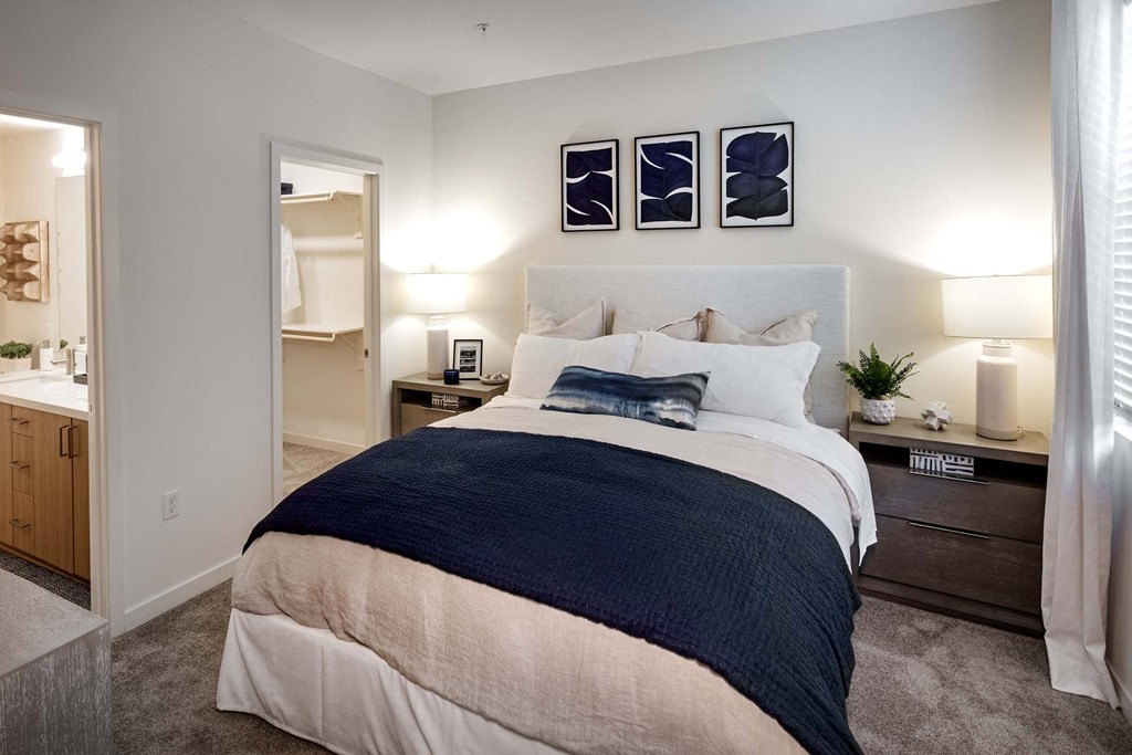 a bedroom with a bed and a bathroom a bedroom with a bed and a bathroom at Luma at El Corazon Apartments, California 92056
