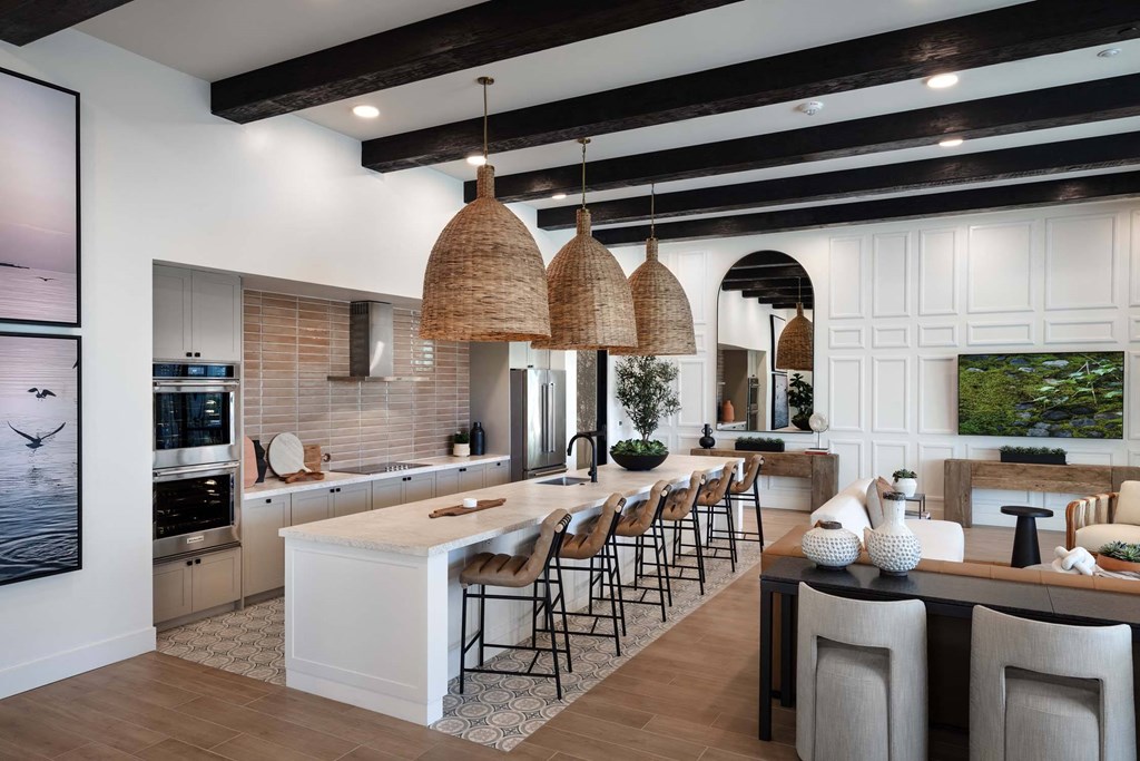 a large kitchen with a large island and bar with stools at Luma at El Corazon Apartments, Oceanside, 92056