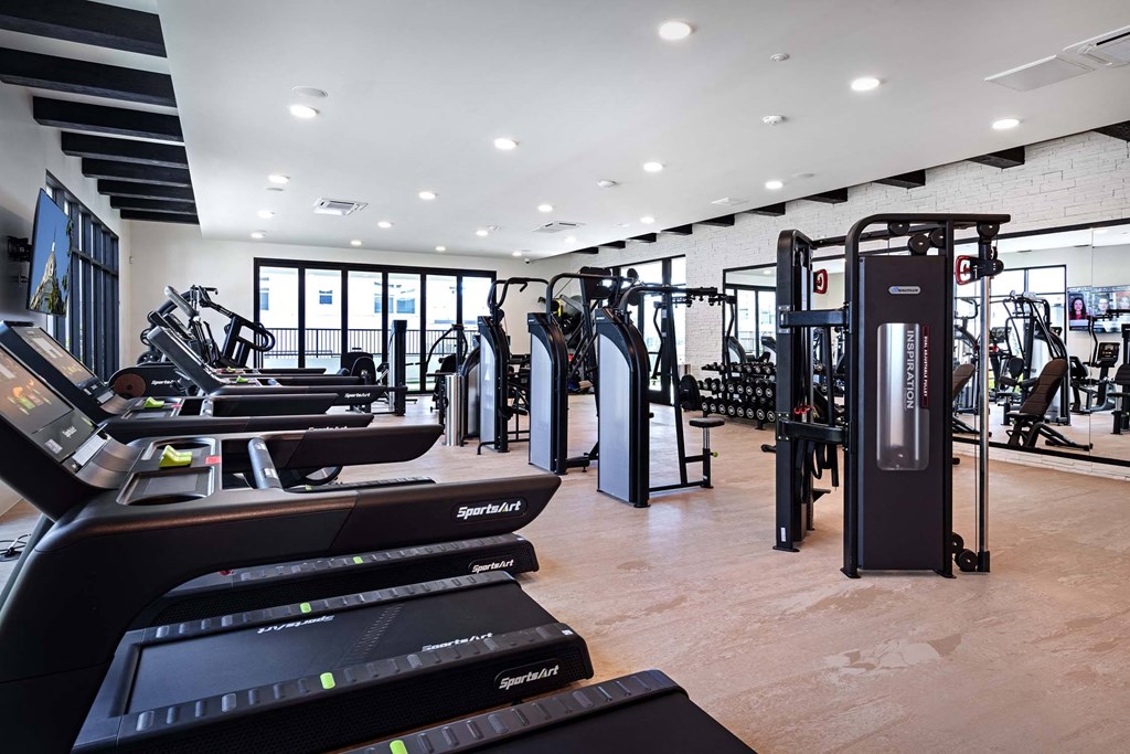 a symmetrical view of a large room with rows of machines at Luma at El Corazon Apartments, California