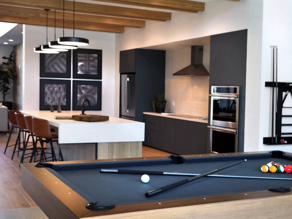 a pool table in the center of a kitchen