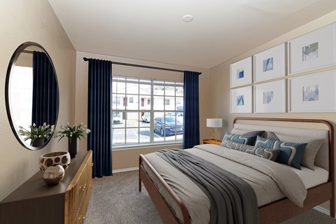 A bedroom with a large bed and a mirror on the wall.