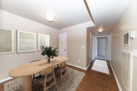 A room with a table and chairs in it.