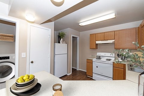 A kitchen with a bowl of lemons on the counter.